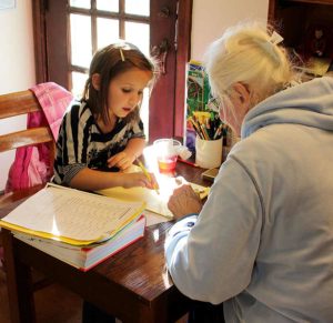 Sister Charles Van Hoy tutors a child after school at Educational/Family Services. 