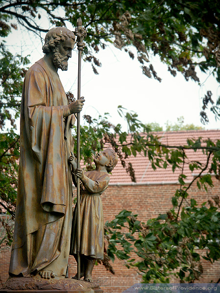 a bronze statue of St. Joseph with Jesus as a small child