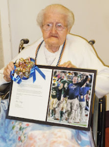 Sister Mary Eymard in 2012 at her 100th birthday party with her autographed photo from Notre Dame’s head football coach, Brian Kelly.