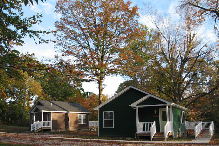 two small cottages nestled under the trees