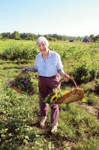 Sister Joan Matthews connects with creation by picking flowers in the gardens at Saint Mary-of-the-Woods.