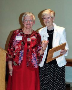 Sister Lois Ann Stoiber, right, accepts the Queen Amelia Award for her brother, Ray, from Sisters of Providence General Superior Sister Denise Wilkinson