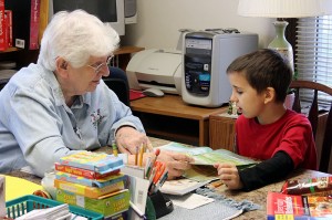 Sister Mary Pat Peacock's volunteer ministries in her later years were many and varied. Here she tutors a little boy at Educational/Family Services in West Terre Haute.