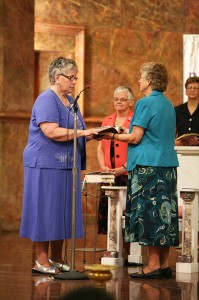 Sister Laura Parker professes perpetual vows as a Sister of Providence at a ceremony on June 30, 2013 at Saint Mary-of-the-Woods, Ind. Sister Jenny Howard holds the Bible as General Superior Denise Wilkinson and Sister Dawn Tomaszewski look on.