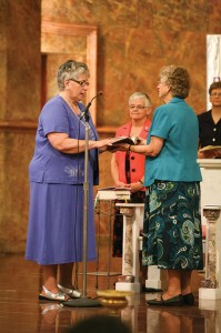 Sister Laura professes life-long vows as a Sister of Providence as Sisters Denise Wilkinson and Jenny Howard look on.