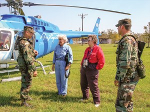 Sister Helen Vinton in blue, is out and about in her ministry in Louisiana. Here she prepares to do damage assessment by helicopter to remote rural coastal areas after Hurricane Katrina (Submitted photo).