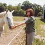 Sister Janice Smith visits with a horse at Saint Mary-of-the-Woods