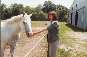 Sister Janice Smith visits with a horse at Saint Mary-of-the-Woods