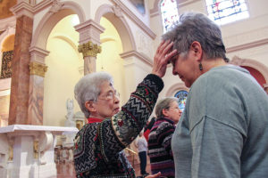 Karen receiving ashes from Sister Adele Beacham during a Ash Wednesday service, says she feels valued by the sisters.
