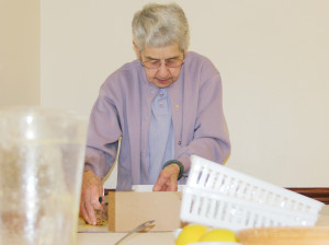 Sister Rose Marita Riordan cleans up following a meeting at the Providence Spirituality and Conference Center.