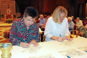 New Providence Associates Diana M. Garza and DeAnna Havel of Texas sign their commitment statements during their commitment ceremony at Saint Mary-of-the-Woods on Oct. 21, 2014.
