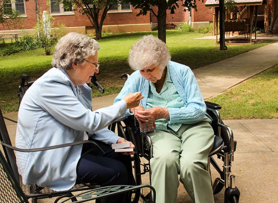 Sister Laurine Haley, left, presents Providence Health Care at Saint Mary-of-the-Woods resident Marianne Frey with a watch that had belonged to her late aunt, Sister Marion Celeste Bisch.