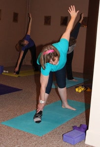 Sister Janice Smith moves between poses at a yoga class Monday afternoon.