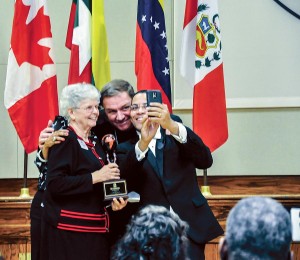 Sister Marikay Duffy poses for a selfie of her and Archbishop Joseph Tobin taken by WRTV-6 news anchor Raphael Sanchez who emceed the Intercultural Awards Dinner of the Archdiocese of Indianapolis at which she was honored. (Photo courtesy of Natalie Hoefer, Criterion)