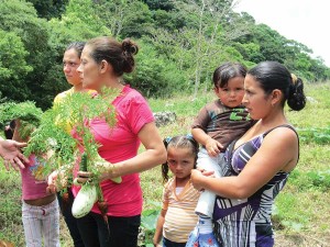 Nicaraguan women and children participate in the organic farming project Maria helps support.