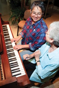 Sister Regina Marie McIntyre, right, gives music lessons to Sister Joni Luna who is in formation with the sisters.