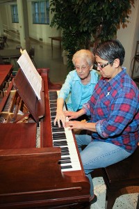 Sister Regina Marie McIntyre instructs Sister Joni Luna on the piano.