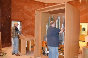Employees from Wicks Organ Company tearing down the organ in Saint Joseph Chapel.