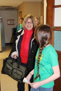 Sister Janice Smith is escorted by a St. Patrick School student to her destination.