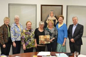 On hand as the Sisters of Providence proclaimed Dr. Dottie King a “Wise Woman of the Woods,” were (from left) General Council members Sisters Jenny Howard, Lisa Stallings (Vicar), Mary Beth Klinger, General Superior Sister Denise Wilkinson, Dr. King, General Council member Sister Dawn Tomaszewski and Saint Mary-of-the-Woods College Board of Trustees Chair Randy Adams.