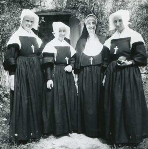 This is a photo of Sister Georgiana Terstegge (third from left) from 1955 during a summer of study in France. She posed with sisters from the Sisters of Providence of Ruillé-sur-Loir.