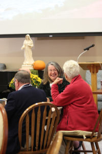 Providence Associate candidate Cindy Montgomery speaks to others at her table.