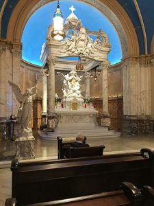 a stately Eucharistic chapel with a painted blue dome ceiling