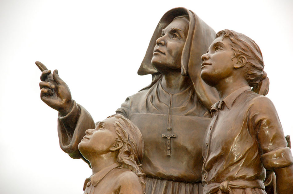 Bronze statue of Mother Theodore teaching two young girls