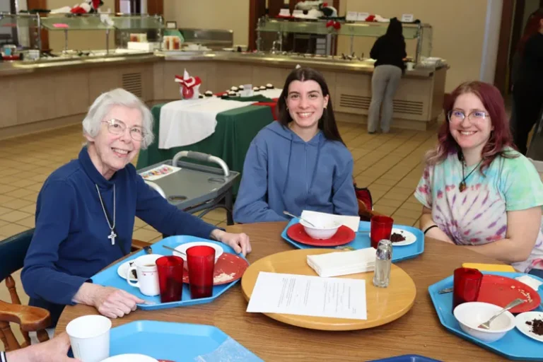 (Above) Sister Rosemary Smaltz enjoying lunch with DePaul University junior Isabella White.