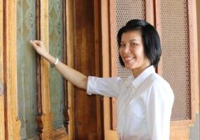 Postulant Ann Duong knocking on the front door of Providence Hall.