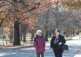 Sister Barbara Sheehan walks and talks with her candidate, Paula Fike Daum.