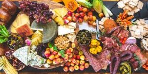Charcuterie board with cheeses, fruits, and meats