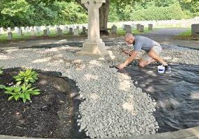 Providence Associate Robb Farris working on beautifying the cross in the Congregation Cemetery.