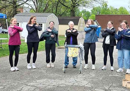 College students and Sister Barbara Ann Bluntzer (center) dancing the Macarena.
