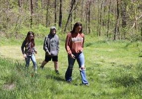 A family getting ready to go on a nature trail walk with forrester Stu Haney.