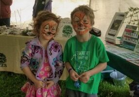 Brother and sister twinned with their tiger face paintings.