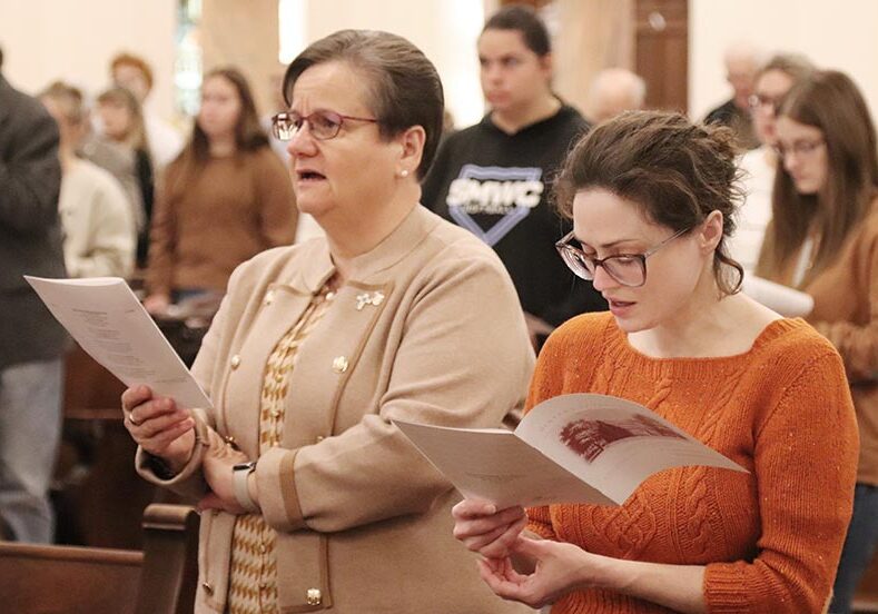 General Councilor Sister Anne Therese Falkenstein (left) singing a hymn next to Saint Mary-of-the-Woods College Archivist Cassie Reddick.