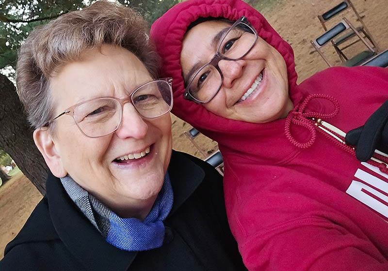 General Superior Sister Dawn Tomaszewski (left) with Sister Joni Luna during a morning prayer service by the Log Cabin Chapel on Foundation Day 2025.