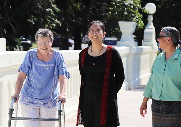 Jessica Sun (center) with (from left) Sister Paula Modaff and Sister Joni Luna crossing the bridge and walking toward Providence Hall.