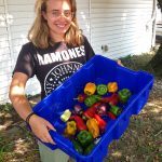 Liv Charlton shows off the fruits of her labor with this tub of USDA organic peppers.