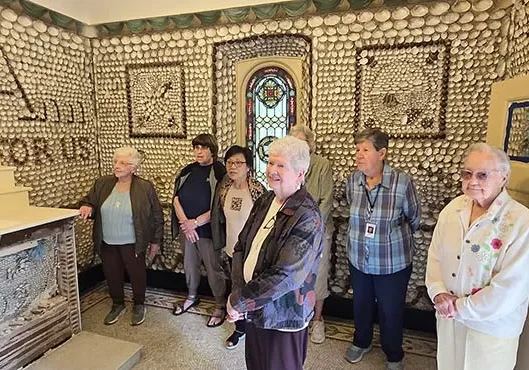 Several Sisters of Providence, including (front, from left) Sister Jan Craven, Sister Noralee Keefe, (back, from left) Sister Marilu Covani, General Councilor Sister Carole Kimes, Sister Editha Ben, Sister Barbara Sheehan and Sister Betty Paul inside the Saint Anne Shell Chapel.