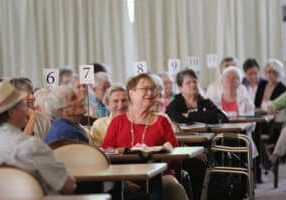 Providence Associate Jane Fischer and others listen during a presentation