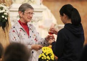 Sister Marilyn Baker offers communion during the 2024 Mass on the Feast Day for Saint Mother Theodore Guerin.