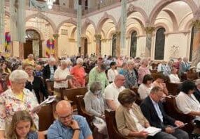 Sisters of Providence in attendance stand and recommit themselves to the mission of Providence and to living out the radical Gospel message of love, mercy and justice during the June 25 celebration of commitment at Saint Mary-of-the-Woods.