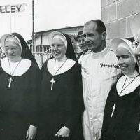 This undated photo shows (from left) Sister Ann Clouser (RIP), Sister Eleanor Bussing (RIP), Sister Amata Dugan (RIP) and Sister Paul Marie Gutgsell (RIP) with Indy 500 driver Parnelli Jones.