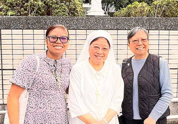 Sister Jessica Vitente (left) and Sister Rose Chiu (right) viiting with Sister Theresa Wang, MSP, at Our Lady of Providence High School near their convent across the street.