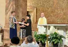 Sister Leslie Dao (center) professing first vows with General Superior Sister Dawn Tomaszewski (left) and Father Terry Johnson.