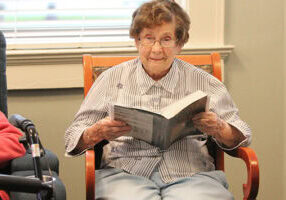 Sister Mary Mark Dede prays in the sunroom in Lourdes Hall.