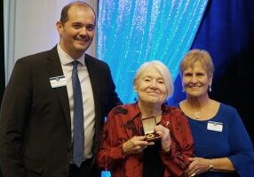Sister Rosemary Nudd (center) receiving the Saint Mother Theodore Guerin Award during the 2024 Saint Mary-of-the-Woods College Reunion banquet with (left) Saint Mary-of-the-Woods College interim president Brennan J. Randolph and (right) Saint Mary-of-the-Woods College Alumni President Lynn O'Linski.