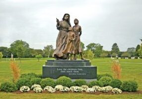 This is the front of the statue with Mother Theodore's famous quote, "Love the children first, then teach them."